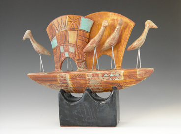 Sculpture of clay featuring 5 cranes on sailboat form with blue glaze highlights by MaryLynn Schumacher.