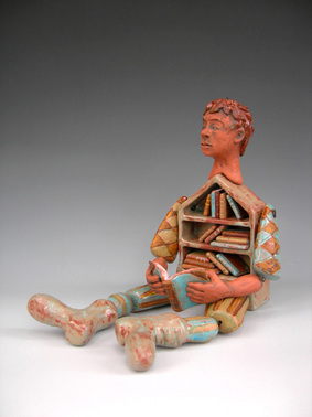 Ceramic Storyteller puppet fashioned of individually sculpted elements, glazed in weathered blue, green,amber glazed, body is cabinet filled with books.