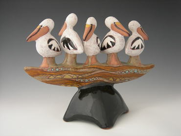 Clay sculpture of 5 pelicans perched on boat by MaryLynn Schumacher