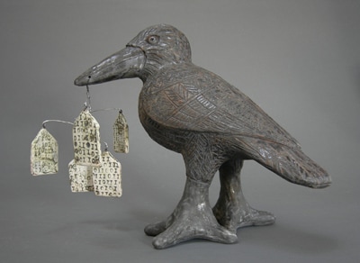 MaryLynn Schumacher ceramic sculpture of raven with house mobile.
