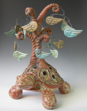 MaryLynn Schumacher clay sculpture of tree of life growing on turtle, with leaves of owls and wings. 