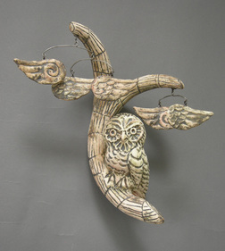 M L Schumacher clay sculpture of wall hanging branch with owl and mobiles of wings, finished in polished white slip patina. 