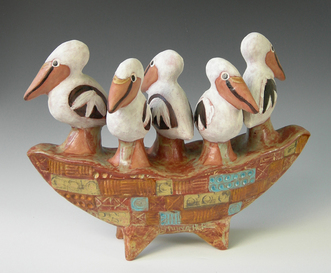 mlschumacher ceramic sculpture of 5 pelicans on patterned textured boat, glazed in blues, greens, amber, and iron brown patina. 